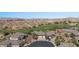 Beautiful aerial view of neighborhood with golf course and mountain views in the background at 653 Paloma Cir, Mesquite, NV 89027