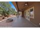 Backyard featuring a covered patio, artificial turf, palm trees and a built in fire pit at 653 Paloma Cir, Mesquite, NV 89027