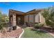 Spacious backyard featuring artificial turf, desert landscaping, and a covered patio at 653 Paloma Cir, Mesquite, NV 89027
