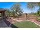 Backyard with artificial turf, covered patio, and desert landscaping with golf course views at 653 Paloma Cir, Mesquite, NV 89027