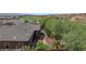 Aerial view of backyard with desert landscaping, palm trees, and covered patio at 653 Paloma Cir, Mesquite, NV 89027