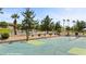 Community basketball and tennis courts with mature trees and desert landscaping at 653 Paloma Cir, Mesquite, NV 89027
