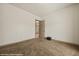 Neutral bedroom with tan carpet and an open door at 653 Paloma Cir, Mesquite, NV 89027