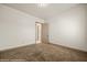 Bedroom with neutral carpet, fresh white paint, and a door to the hallway at 653 Paloma Cir, Mesquite, NV 89027
