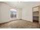 Bright bedroom with neutral carpet, a closet, and a large window at 653 Paloma Cir, Mesquite, NV 89027