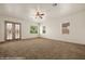 Bright bedroom with carpet, ceiling fan, and access to the outdoor with double doors and windows at 653 Paloma Cir, Mesquite, NV 89027