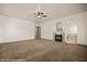 Large bedroom showcasing a fireplace, carpeted floor, and an arched doorway to another room at 653 Paloma Cir, Mesquite, NV 89027