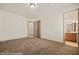 Bedroom showcasing neutral walls, plush carpet, and doorways leading to a bathroom and hallway at 653 Paloma Cir, Mesquite, NV 89027