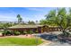 Beautiful community clubhouse with a green tile roof, desert landscaping and mature trees at 653 Paloma Cir, Mesquite, NV 89027