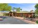 Spacious community clubhouse featuring a green tile roof, desert landscaping and mature trees at 653 Paloma Cir, Mesquite, NV 89027