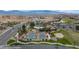 This is an aerial view showcasing the resort-style pool, tennis courts, and desert landscape at 653 Paloma Cir, Mesquite, NV 89027