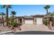 Beautiful single Gathering home with a three-car garage, stone accents, and desert landscaping at 653 Paloma Cir, Mesquite, NV 89027