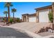 Beautiful single Gathering home with a three-car garage, stone accents, and desert landscaping at 653 Paloma Cir, Mesquite, NV 89027
