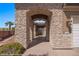 View of the ornate wrought iron gated entrance to the home with stone archway and desert landscaping at 653 Paloma Cir, Mesquite, NV 89027