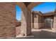 View of the ornate wrought iron gated entrance to the home with stone archway and desert landscaping at 653 Paloma Cir, Mesquite, NV 89027