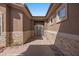 View of the ornate wrought iron gated entrance to the home with stone accents and a desert landscaped yard at 653 Paloma Cir, Mesquite, NV 89027