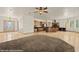 Spacious open-concept living room with kitchen island, tile floor and front door view at 653 Paloma Cir, Mesquite, NV 89027