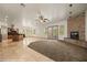 Open-concept living room featuring a stone fireplace and access to the backyard at 653 Paloma Cir, Mesquite, NV 89027