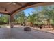Covered patio featuring a built-in fire pit, ceiling fans and views of the golf course at 653 Paloma Cir, Mesquite, NV 89027