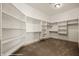Spacious walk-in closet featuring ample shelving, hanging space, and carpeted floor at 653 Paloma Cir, Mesquite, NV 89027