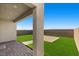 Relaxing covered patio with synthetic grass and brick accents, perfect for outdoor enjoyment at 6854 Chargehand Ave, Las Vegas, NV 89156
