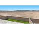 Open backyard view with mountain landscape, a block wall, and artificial turf at 6854 Chargehand Ave, Las Vegas, NV 89156