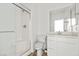 All-white bathroom with glass shower, toilet, and modern vanity at 6854 Chargehand Ave, Las Vegas, NV 89156