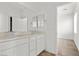 Clean, well-lit bathroom with double sinks, vanity, and a view to another room at 6854 Chargehand Ave, Las Vegas, NV 89156