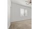Neutral bedroom featuring a large window with blinds and ceiling fan at 6854 Chargehand Ave, Las Vegas, NV 89156