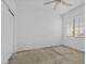 Well-lit bedroom featuring a large window with blinds and neutral carpet at 6854 Chargehand Ave, Las Vegas, NV 89156