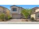 Beautiful two-story home with a brick driveway, tan stucco, stone facade, and a two-car garage at 6854 Chargehand Ave, Las Vegas, NV 89156