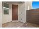 Inviting front entrance with a stone-paved porch and a stylish brown front door, ensuring a warm welcome at 6854 Chargehand Ave, Las Vegas, NV 89156