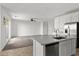 Kitchen and living room area with stainless steel appliances, white cabinets and seamless connectivity at 6854 Chargehand Ave, Las Vegas, NV 89156
