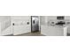 Bright kitchen boasts white cabinetry, stainless steel appliances, an island with sink and tile floors at 6854 Chargehand Ave, Las Vegas, NV 89156