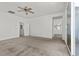 Spacious living room with access to bathroom and lots of natural light from the window and glass sliding door at 6854 Chargehand Ave, Las Vegas, NV 89156