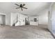 Bright, open-concept living room and kitchen features neutral carpeting and white paint, creating a modern feel at 6854 Chargehand Ave, Las Vegas, NV 89156