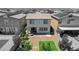 Aerial view of backyard featuring artificial grass, patio, and two-story home at 7246 Dazzle Point St, North Las Vegas, NV 89084