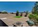 Landscaped backyard with brick pavers, gravel, grass patch, and BBQ area at 7246 Dazzle Point St, North Las Vegas, NV 89084