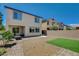 Rear exterior showcasing a patio, artificial turf, desert landscaping, and two-story home at 7246 Dazzle Point St, North Las Vegas, NV 89084
