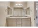Bright bathroom featuring dual sinks, granite counters, updated fixtures and mirrors at 7246 Dazzle Point St, North Las Vegas, NV 89084