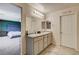 Bright bathroom with double vanity, granite counters, tiled floors and access to the primary bedroom at 7246 Dazzle Point St, North Las Vegas, NV 89084