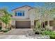 Charming two-story stucco home featuring a brick driveway, desert landscaping, and attached two-car garage at 7246 Dazzle Point St, North Las Vegas, NV 89084