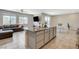 Open concept kitchen with granite island, stainless steel appliances and tile flooring adjoining the living area at 7246 Dazzle Point St, North Las Vegas, NV 89084