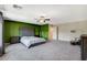 Expansive primary bedroom with gray carpet, accent wall, ceiling fan, and neutral paint throughout at 7246 Dazzle Point St, North Las Vegas, NV 89084