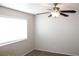 Bright bedroom features carpet flooring, a ceiling fan, neutral walls and a window at 7570 Durham Hall Ave # 101, Las Vegas, NV 89130