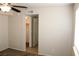 Bedroom with neutral walls, carpet flooring, ceiling fan, and a view into the walk-in closet at 7570 Durham Hall Ave # 101, Las Vegas, NV 89130
