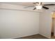 Bedroom featuring neutral walls, carpet flooring, ceiling fan, and a glimpse into a walk-in closet at 7570 Durham Hall Ave # 101, Las Vegas, NV 89130