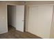 This bedroom features carpet flooring and dual closets at 7570 Durham Hall Ave # 101, Las Vegas, NV 89130