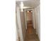Hallway featuring tile flooring, neutral walls and leading to a room with a ceiling fan at 7570 Durham Hall Ave # 101, Las Vegas, NV 89130