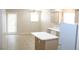 Bright kitchen with an island, white appliances, and a sliding glass door at 7570 Durham Hall Ave # 101, Las Vegas, NV 89130